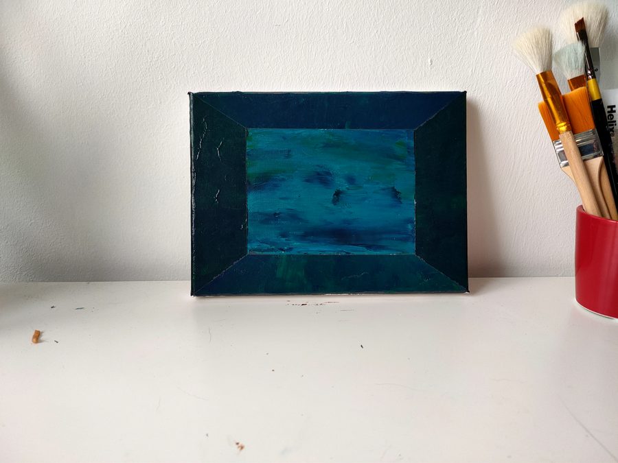 A teal seascape held inside a deep blue painted border.