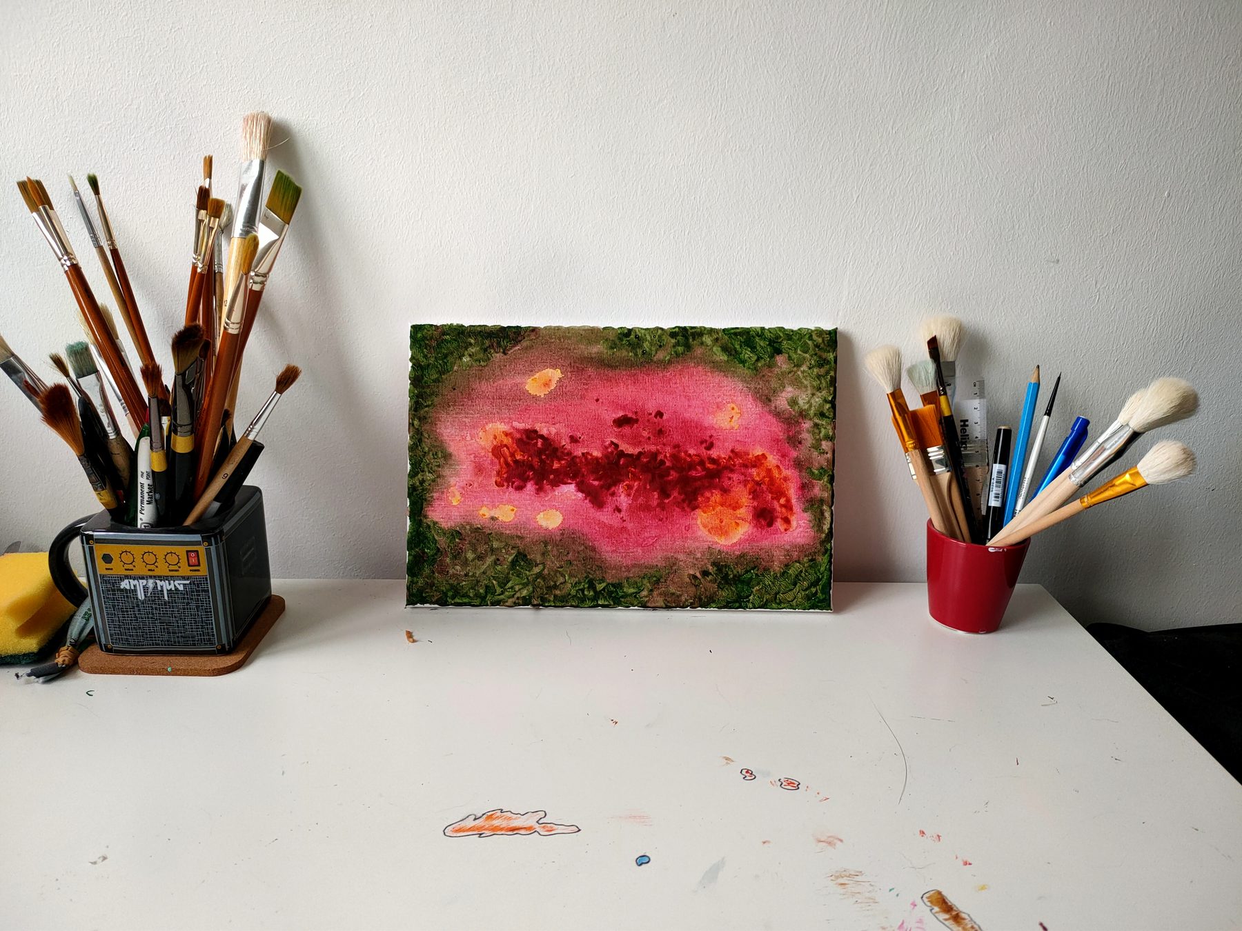 A bloom of magenta and pink opening across a dark mossy green ground.