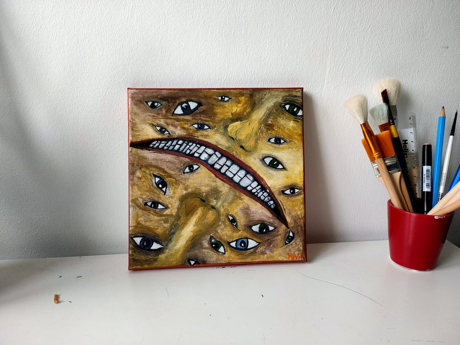 Ochre and gold forms crowded with painted eyes, a row of teeth running through them.