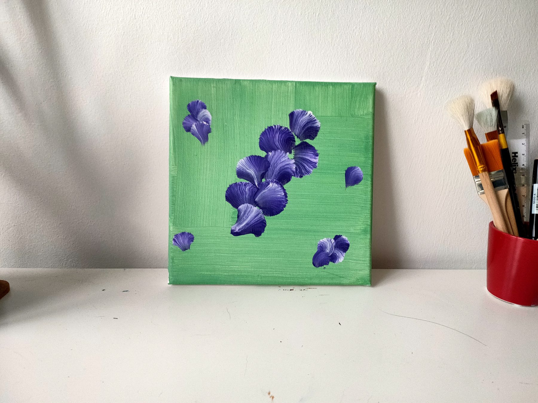 Purple iris petals falling across a bright green ground.